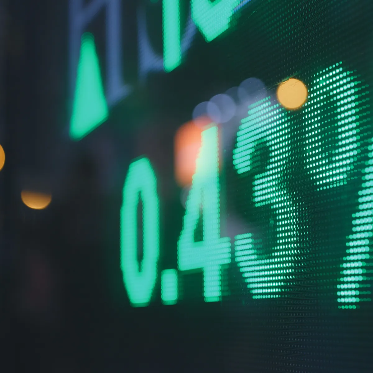 A market ticker display showing a percentage figure in green